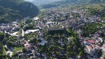 Aerial orbiting shot over the Walled City of Jajce and Jajce Fortress on steep hill, Bosnia and Herzegovina