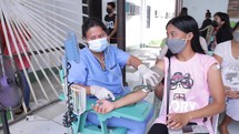 Asian Nurse Taking Womans Blood Pressure Covid Screening