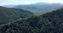 Scenic Mountain Views With Lush Green Forest In Romania - aerial shot