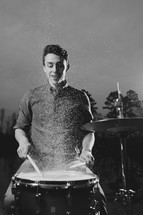 young man playing wet drums