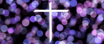 white cross on bokeh purple lights background 