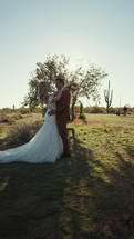 Bride and groom eloping in the desert