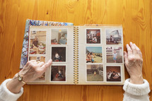 Top view of a senior woman looking through old photo albums themes of memories nostalgia photos retired	