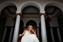 bride sitting in a red chair 