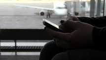 a person texting at the airport 
