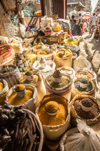 seeds, spices, grains, and herbs in baskets in a market in Haiti 