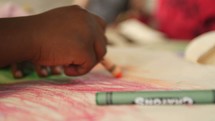 toddlers coloring with crayons 