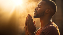 African American man praying earnestly 