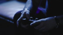 Using controller playing video games - close up of hands and joypad
