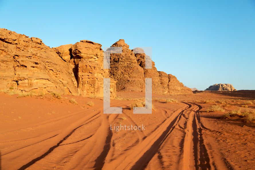 tire tracks in desert sand 