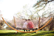 man and woman kissing on a hammock