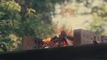 Brick BBQ alight, burning wood barbecue, camp fire outdoor cooking video	
