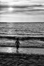 child running towards the ocean 