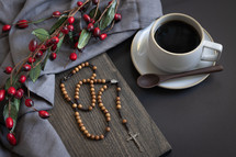 rosary, coffee and red berries, with cross, above