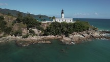 Drone Aerial View Of Beautiful Lighthouse On Tropical Coastline Shipwrecks And Shallow Water Historical Navigation
