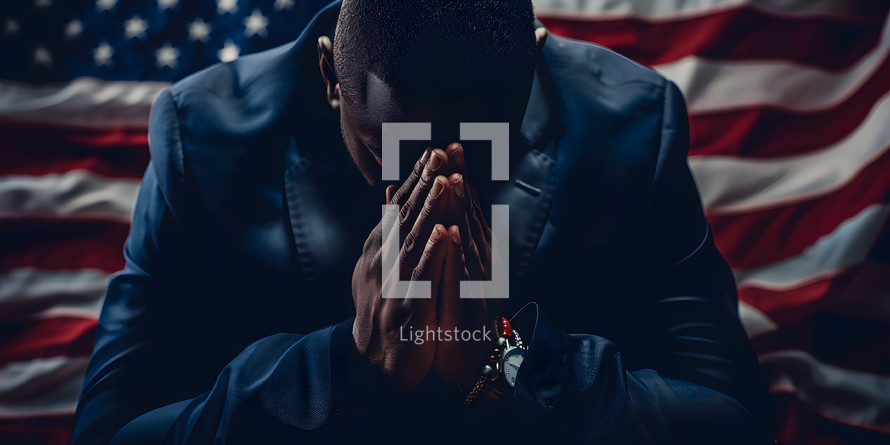 Man praying with the American Flag behind