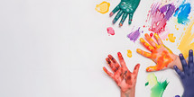 children's painted hands and hand prints on a white background