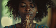 Woman close up with hands praying near face