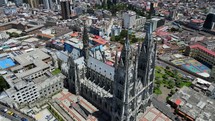 Aerial shot drone does almost a full circle around the Basilica del Voto Nacional in downtown Quito