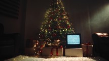 Christmas tree and tv with static noise in the room