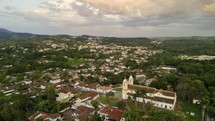 Drone orbits completely around Igreja de Santo Antonio in Tiradentes, Brazil at sunset
