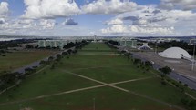 Drone flies down Esplanade of Ministries in Brasilia, Brazil on partly cloudy day
