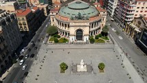 Aerial shot drone lowers on Teatro Politeama Garibaldi while panning up in the Piazza Ruggero Settimo in Palermo, Sicily, Italy