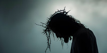 Jesus looks down wearing crown of thorns, blood drips from crown, copy space