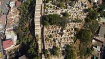 Aerial shot drone flies high over cemetery with camera at sharp angle facing down