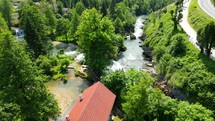 Aerial shot drone flies along river away from large waterfalls in Rastoke, Slunj, Croatia