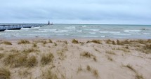 4K Aerial Lake Michigan Lighthouse Pier Sand Dunes Waves Water Beach Flyover