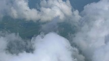 4K Aerial Windmills Renewable Energy Power Plant Paralax Through Clouds Airplane Flying