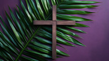 Lent flat lay with purple background, cross, and palm leaf