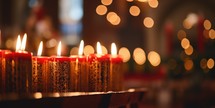 A row of candles on a table during a Christmas service.