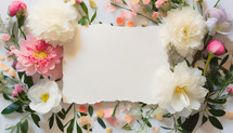 blank paper with torn edges surrounded by flowers and leaves
