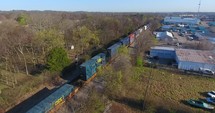 4K Aerial Freight Train Box Cars Flyover Nashville Tennessee Tracks Following Circle Right