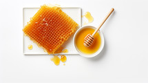 Bright clean honeycomb and honey flat lay