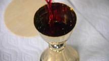 Wine being poured into a goblet during mass.