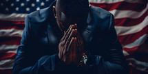 Man praying with the American Flag behind