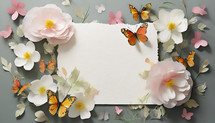 butterflies and flowers arranged around a deckle-edged page, flat lay design
