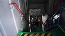 Asian Ferry Workers walking into engine room of big ship Mechanic