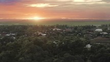Aerial Drone Captures Beautiful Asian Sunrise in Palm Trees Village