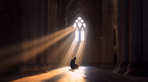 Silhouette of a man praying alone sitting in a cathedral