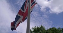 4K British Flags Leading Into Buckingham Palace London England Capital Slider Shot