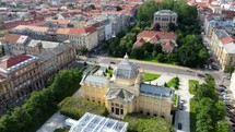 Aerial shot drone orbits to the right around art pavillion in Zagreb, Croatia
