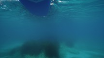 Oar of stand up paddle seen from underwater in the sea