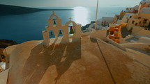 inspirational Shot of Church Bells Cycladic Houses and the Aegean Sea in Santorini Greece