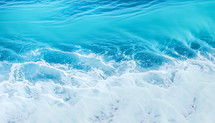ocean surface with white foam and beautiful turquoise blue water