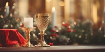 A communion cup  and candle during Christmas on a table in service.
