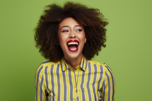 AI Generated Image. Excited African American young woman wearing striped blouse. Studio shot